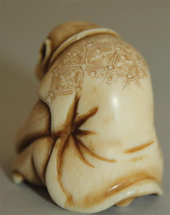 A Japanese ivory netsuke of a monkey viewing an insect through a magnifying glass, signed Masatami, Edo period, 3.6cm